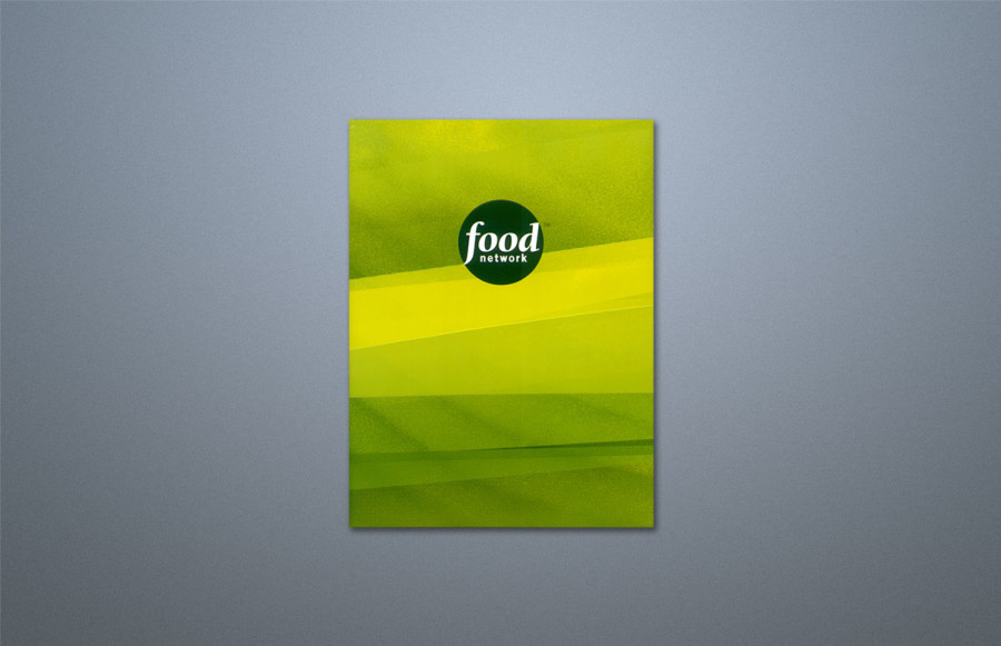 benchmark-food-network1 Die-Cut Folder: 26.5" x 18" open size, custom die-cut folder printing 6-cp (Hexachrome) + overall gloss varnish over 1 PMS + overall dull varnish (7/2). Matte film laminate 2/sides. Die-cut, multi-level emboss, deboss and glue flaps. Winner 2004 AGC Showcase Award