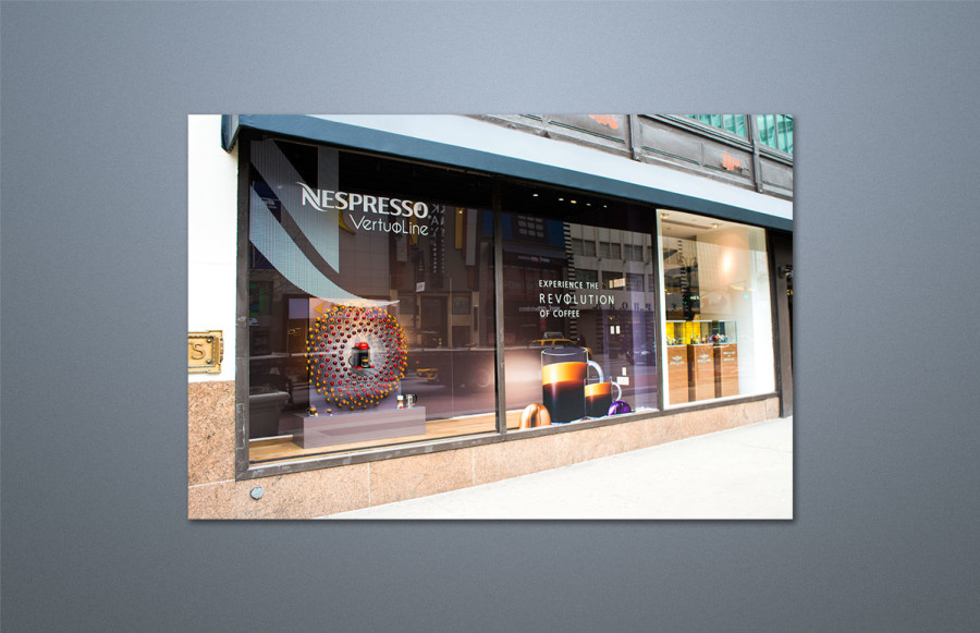 benchmark-nespresso1 VirtuoLine Retail Window Installations: Rush installation of two windows at Macy*s New York flagship store followed by a similar installation in the Macy's Chicago store. Review drawings, scale all items to clients' instructions, create PDFs for approval, image all graphics, CAD cut lettering on clear adhesive vinyl, backgrounds printed on SAV. All for immediate installation. Package and ship overnight via dedicated courier all materials for Chicago installation.