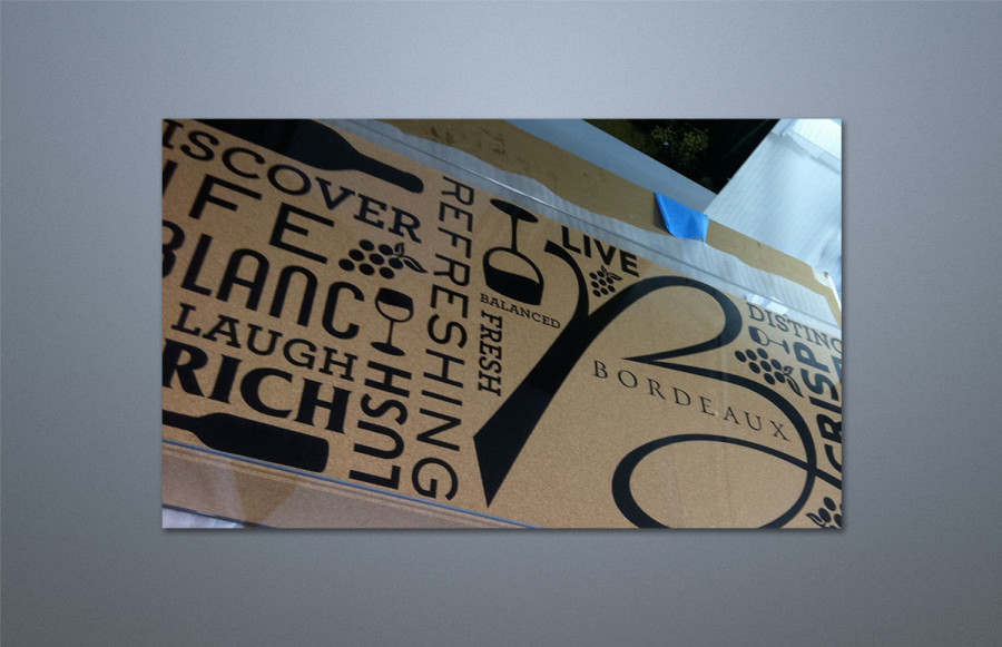 Bordeaux Display Case: 30" x 96" x 6" Custom laser etched to client's pattern on ¼" cork mounted to 4 ½" foam fill. Sides of foam also covered in cork. Entire display encased in ¼" plexiglass and packed for cross country shipping. Photos show unit prior to packing. Also shown is three color custom fabricated table skirt measuring 30" x 96" x 30" made out of black poly poplin "linen." The unit was used as a service bar at a trade show.